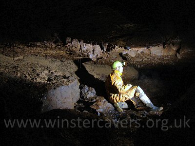 The dark, decorated stream passage in Lathkiller Hall, Lathkill Head Cave
